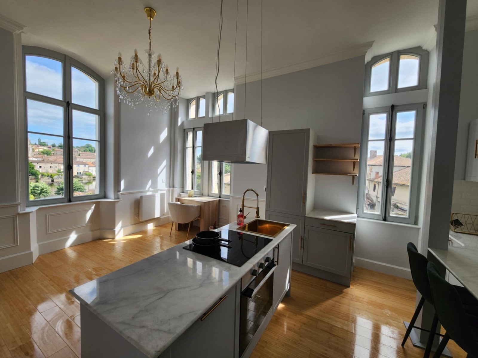A fully fitted modern kitchen with stone worktops